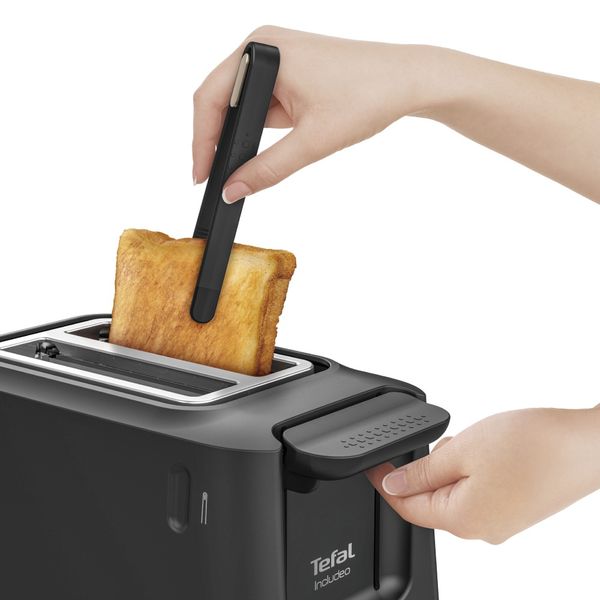 Prăjitor de p&acirc;ine Tefal Includeo TT533811, 850W, capacitate 2 felii, 7 trepte de rumenire, buton oprire, clește inclus, m&acirc;ner ridicare, negru & auriu